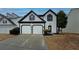 Charming two-story home featuring an attached two-car garage, neutral siding, and well-maintained landscaping at 2587 Alvecot Se Cir, Atlanta, GA 30339