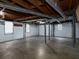 Unfinished basement featuring a garage door, support beams, and natural light at 286 Sequoia Ne Dr, Marietta, GA 30060