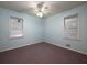 This bedroom features neutral-colored walls and carpet, with two windows and a ceiling fan at 286 Sequoia Ne Dr, Marietta, GA 30060