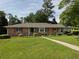 Charming brick home featuring a lush green lawn and mature trees at 286 Sequoia Ne Dr, Marietta, GA 30060