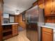 Open kitchen with stainless steel refrigerator, abundant wood cabinetry, and a view into the living room at 286 Sequoia Ne Dr, Marietta, GA 30060