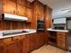 Open kitchen featuring wooden cabinetry, a black stovetop, and a modern oven appliance at 286 Sequoia Ne Dr, Marietta, GA 30060