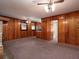 Living room with wood paneling, carpeted floors and classic ceiling fans at 286 Sequoia Ne Dr, Marietta, GA 30060