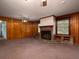 Spacious living room featuring a brick fireplace, hardwood-paneled walls, and plenty of natural light at 286 Sequoia Ne Dr, Marietta, GA 30060