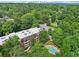Aerial view of a large apartment complex with a pool in a lush green setting, near the city at 302 Ridley Howard Ct # 302, Decatur, GA 30030
