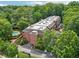 Aerial view of a brick apartment building with a pool and surrounding lush greenery at 302 Ridley Howard Ct # 302, Decatur, GA 30030