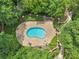 Aerial view of a serene pool area nestled within lush landscaping, creating a private oasis at 302 Ridley Howard Ct # 302, Decatur, GA 30030