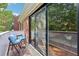 Cozy balcony with seating, offering serene views of the surrounding greenery through sliding glass doors at 302 Ridley Howard Ct # 302, Decatur, GA 30030