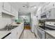 Well-lit kitchen features white cabinetry, modern appliances, and a view into the dining area at 302 Ridley Howard Ct # 302, Decatur, GA 30030