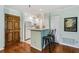 Cozy kitchen with white cabinets, breakfast bar, hardwood floors, and updated appliances at 302 Ridley Howard Ct # 302, Decatur, GA 30030