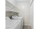 Functional laundry room equipped with a washer, dryer, and shelving for storage solutions at 302 Ridley Howard Ct # 302, Decatur, GA 30030