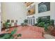 Grand lobby with terra cotta tile, a soaring ceiling, and abundant greenery, evoking a tranquil indoor garden at 302 Ridley Howard Ct # 302, Decatur, GA 30030