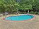 Serene pool area featuring ample seating and lush greenery, perfect for relaxation and outdoor enjoyment at 302 Ridley Howard Ct # 302, Decatur, GA 30030