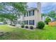 Picture of the backyard featuring a well-maintained lawn, shrubbery, and the side view of the home at 6181 E Fayetteville Dr, Riverdale, GA 30296