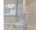Large bathtub and shower combination next to a window at 6181 E Fayetteville Dr, Riverdale, GA 30296