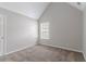 Bedroom offers neutral walls, carpet, a double-hung window, and a vaulted ceiling at 6181 E Fayetteville Dr, Riverdale, GA 30296