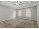 Large primary bedroom features carpet, a ceiling fan, and tray ceiling at 6181 E Fayetteville Dr, Riverdale, GA 30296