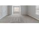 Carpeted bedroom featuring two windows at 6181 E Fayetteville Dr, Riverdale, GA 30296
