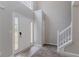 Bright foyer featuring a staircase with white railing, tile flooring, and high ceilings at 6181 E Fayetteville Dr, Riverdale, GA 30296