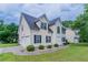 Two-story home with attached garage, manicured lawn, and symmetric shrubbery lining the walkway at 6181 E Fayetteville Dr, Riverdale, GA 30296