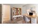 Functional home office with a desk, chair, bookshelf, and plenty of natural light at 6181 E Fayetteville Dr, Riverdale, GA 30296
