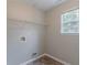 Laundry room with overhead wire rack shelving and linoleum flooring at 6181 E Fayetteville Dr, Riverdale, GA 30296