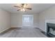 Spacious living room with a fireplace and view of dining room at 6181 E Fayetteville Dr, Riverdale, GA 30296