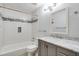 Updated bathroom features a tub with subway tile surround and marble countertop vanity with modern fixtures at 1404 N Crossing Ne Dr, Atlanta, GA 30329
