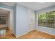 Light blue bedroom features hardwood floors, a window with blinds, and built-in storage at 1404 N Crossing Ne Dr, Atlanta, GA 30329