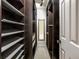 Walk-in closet with custom shelving and a mirror at the end of the hall at 1404 N Crossing Ne Dr, Atlanta, GA 30329