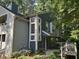 Two-story home with gray and blue siding, white trim, large windows, and front yard foliage at 1404 N Crossing Ne Dr, Atlanta, GA 30329