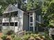 Inviting two-story townhome showcasing mature trees, a private balcony, and serene outdoor living spaces at 1404 N Crossing Ne Dr, Atlanta, GA 30329