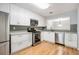 Well-lit kitchen with white cabinets, gray backsplash, stainless steel appliances, and hardwood floors at 1404 N Crossing Ne Dr, Atlanta, GA 30329