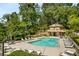 Community pool featuring comfortable lounge chairs, shade trees, and a covered pool house at 1404 N Crossing Ne Dr, Atlanta, GA 30329