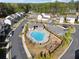 Aerial view of a community pool with surrounding lounge chairs and a playground at 1621 Wellborn Walk, Suwanee, GA 30024