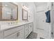 Bright bathroom with double vanity, framed mirrors, and a glass-enclosed shower with tiled walls at 1621 Wellborn Walk, Suwanee, GA 30024