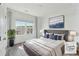 Inviting bedroom features neutral tones, a plush bed, and a bright window view of the outdoors at 1621 Wellborn Walk, Suwanee, GA 30024