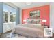 Bright bedroom with large windows, stylish décor, and a comfortable-looking bed with soft pillows at 1621 Wellborn Walk, Suwanee, GA 30024