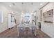 Bright dining area with modern table and chairs leading to a stylish, well-equipped kitchen at 1621 Wellborn Walk, Suwanee, GA 30024
