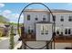 Rear view of a three-story townhouse with a deck and a garage at 1621 Wellborn Walk, Suwanee, GA 30024