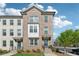 Charming brick townhouse with well-manicured front yard and inviting entrance at 1621 Wellborn Walk, Suwanee, GA 30024