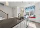 Kitchen island with a stainless sink and countertop, complemented by a breakfast bar and window seat at 1621 Wellborn Walk, Suwanee, GA 30024