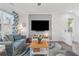 Bright living room featuring a large window, plush seating, and media setup at 1621 Wellborn Walk, Suwanee, GA 30024