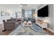 Inviting living room with large windows, modern decor, and stylish rug at 1621 Wellborn Walk, Suwanee, GA 30024