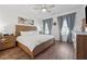 Spacious main bedroom with wood floors, a ceiling fan, and large windows allowing for natural light at 1621 Wellborn Walk, Suwanee, GA 30024
