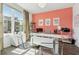 Bright office space with trendy pink wall, modern desk, and plentiful natural light at 1621 Wellborn Walk, Suwanee, GA 30024