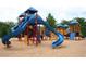 Community playground with slides, climbing structures, and protective mulch ground covering at 1621 Wellborn Walk, Suwanee, GA 30024
