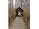 Community boardwalk and covered pavilion walkway, lined with tall trees and greenery at 1621 Wellborn Walk, Suwanee, GA 30024