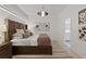 Bright bedroom featuring neutral tones, stylish light fixture, and ensuite bathroom at 560 Dutch Vly # 02313, Atlanta, GA 30324