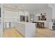 Open-concept kitchen and dining area with a large kitchen island, stainless appliances, and modern lighting fixtures at 560 Dutch Vly # 02313, Atlanta, GA 30324